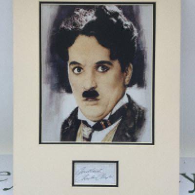A framed and signed photo display of Charlie Chaplin, approx 30cm x 40cm. Comes with COA. Please note that we are not experts in this field and can offer no guarantees that these signatures are genuine and will not be held responsible should they prove otherwise.