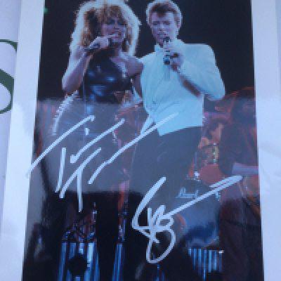 A signed photo of David Bowie and Tina Turner, approx 20cm x 26.5cm.
