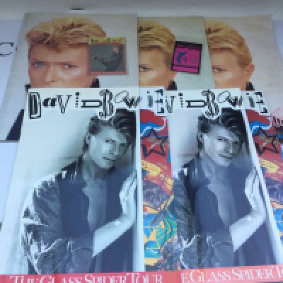 Five David Bowie tour programmes comprising three for the Serious Moonlight tour and two for the Glass Spider tour with accompanying tour laminate and ticket.