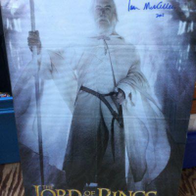 An Ian McKellen signed Lord Of The Rings poster, approx 50cm x 73cm plus a magazine pullout signed by Bernard Hill (2).