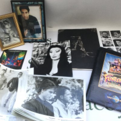 A collection of film memorabilia comprising Rain Man lobby cards, an Addams Family press pack with a signed Anjelica Houston photo, other signatures including Brigitte Bardot, David Schwimmer etc.