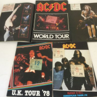 Five AC/DC concert programs and tickets, various dates.