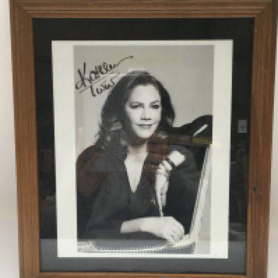 A framed and signed photo of Kathleen Turner. No COA. Please note that buyers must satisfy themselves as to the authenticity of any signed items before bidding as we are not experts in this field and will not be held responsible should they prove to be anything other than genuine.
