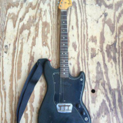 A 1978 Fender Musicmaster electric guitar modified with two jack plates and replacement tone and volume pots plus further modifications. Comes with a Fender branded soft carry case.