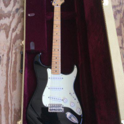 A 2014 Mexican Fender Stratocaster electric guitar with hard carry case. As new condition. Serial number MX13428427.