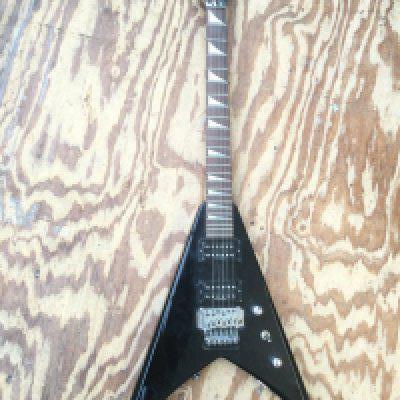 A Jackson 'Flying V' electric guitar. No case.