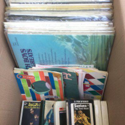 A box of LPs, 78s and 8 track cartridges by various artists including Johnny Cash, The Beach Boys, Santana and others. Also includes spare single sleeves.
