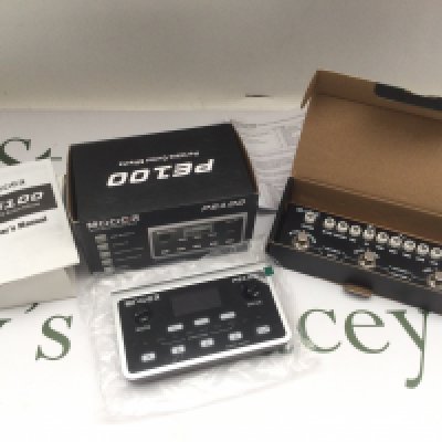 Two boxed guitar effects processors comprising a Mooer PE100 and an M-Vave Cube Baby.