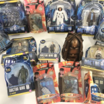 A Box Containing Doctor Who Figures and toys.