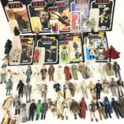 A Collection of Vintage Star Wars Figures With some Backing Cards And accessories.