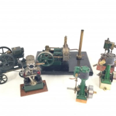 A small collection of live steam engine models plus a McCormack Deering toy cart.