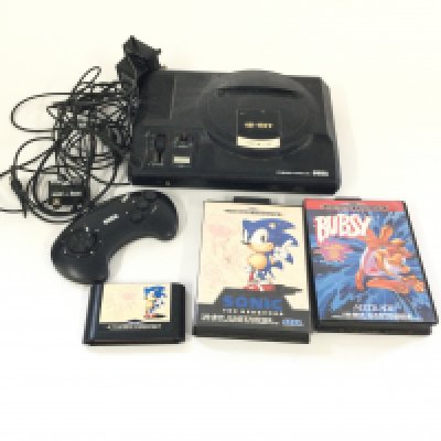 A bag containing a SEGA mega drive, including 1 controller, 2 Boxed games and 1 loose game.