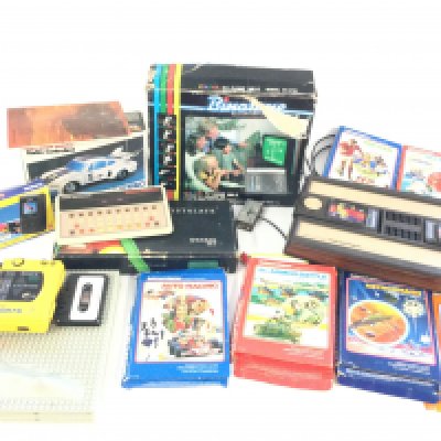 A box containing a Mattel Intellivision plus 6 games, also a Mattel Brain Baffler, a Sony Walkman Sports, a boxed Binatone colour TV game, a Boxed Casio TV-600 pocket TV, a Boxed Motora-wave car, plus a set of Crystalite snooker balls.
