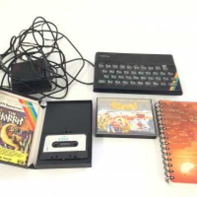 A box containing a Sinclair ZX Spectrum including 2 games, Arcade hall of fame and The Hobbit.