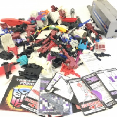 A collection of of Transformers parts and accessories