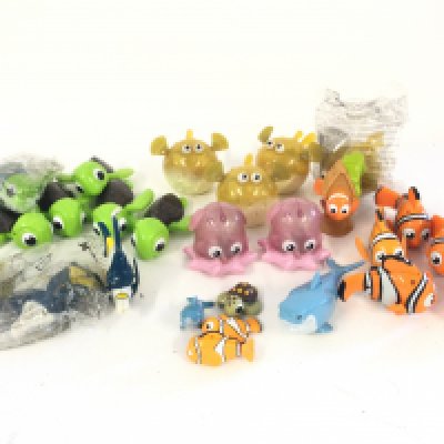 A box containing a quantity of toys and collectibles including Finding Nemo. Star Wars. Disney and Tetley Tea. As well as others.