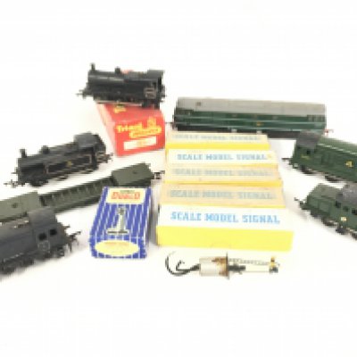 A box containing a collection of 00 Gauge locomotives. Tenders. Coaches. Signals. Track and transformer.