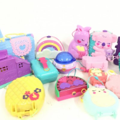 A Box Containing A Collection Of Polly Pockets And Accessories.