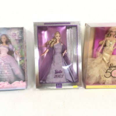 A collection of three boxed Barbie dolls featuring The Fairy Queen..Barbie 2003..Barbie 50. (3)