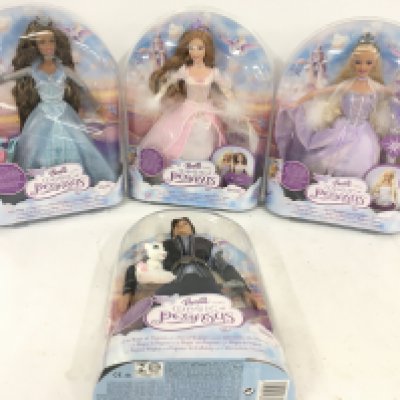 A collection of four boxed Barbie figures from the Magic of Pegasus series featuring Rayla..Brietta..Barbie..Adam (4)