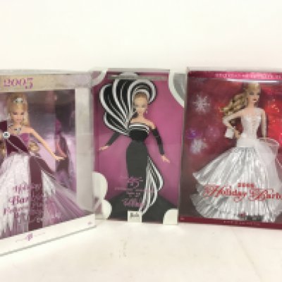 A collection of three boxed Barbie dolls featuring 2005 Holiday Barbie..2008 Holiday Barbie and 45th Anniversary Barbie (3)