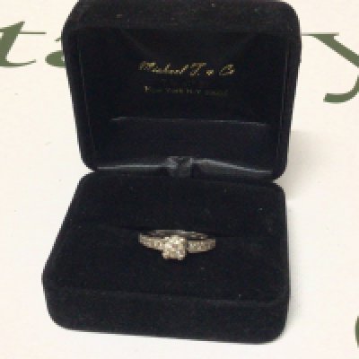 withdrawn - An 18carat white gold ladies ring set with a central brilliant cut diamond. Approximately 0.44 of a carat I J colour and VS Clarity as stated on purchase receipt. Cost price $2700 US dollars The central stone the central brilliant cut diamond flanked by ten further diamonds set in the ring. Ring size K weight 4.4g