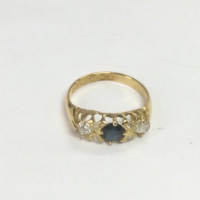 An 18ct gold, three stone diamond and sapphire ring, approx 2.9g and approx size K. Shipping category A.