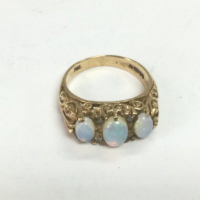 A 9ct gold three stone opal ring, approx 5.2g and approx size M-N. Shipping category A.