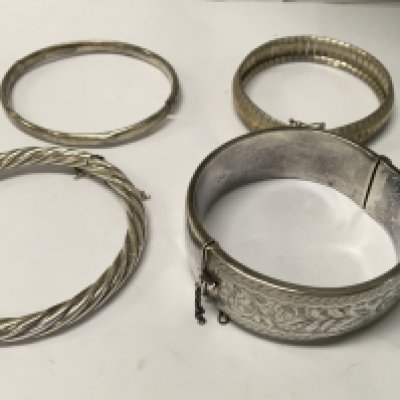 A collection of four silver bangles . NO RESERVE