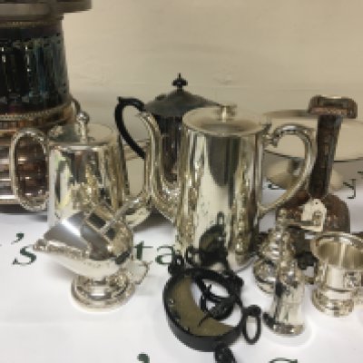 A box containing silver plate including a food warmer tea and coffee pots candle sticks and other ornaments including a vintage hanging scale NO RESERVE
