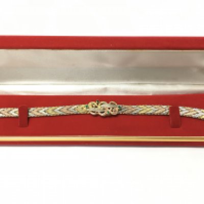 A three colour silver gilt bracelet , postage category A