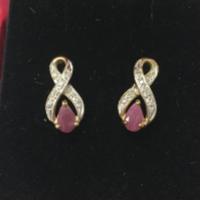 A pair of 9ct gold earring set with ruby and diamonds , 1.3G total weight. Postage category A