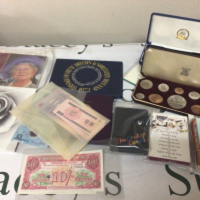 A cased 1953 proof coin set bank notes other commemorative coins and playing cards.