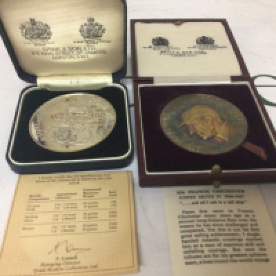 A silver Queen Mum commemorative 1980 medal made by Spinks 82g Sterling Silver and a limited edition Silver Sir Francis Chichester Gypsy Moth IV Airanortrcal Medallion with signed certification. (2)