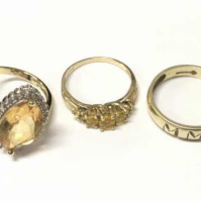 Three 9 carat gold rings including a citrine cocktail ring, MMI ring, yellow sapphire dress ring. 9.3G total weight. Postage cat A