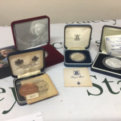 A collection of three silver commemorative coins and a bronze coin (4)