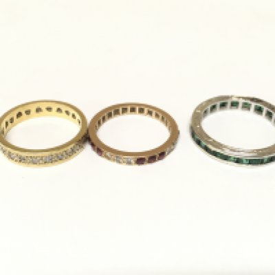 Three unmarked rings set with various gems including diamonds. Approximately 7.3g and sizes K & N