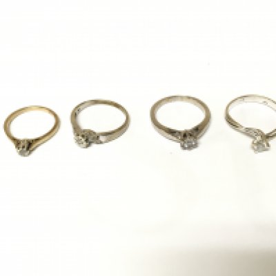 Four unmarked rings three with diamond and one with white stones. Approximately 10.10g Size K O & P