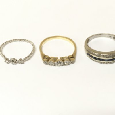 Three unmarked rings set with various gems including diamonds. Approximately 6g sizes K N and O