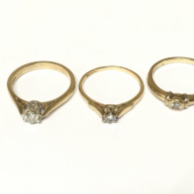 Three 9ct gold diamond solitaire rings. Approximately 6g and sizes M 1/2 and N