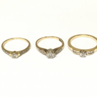 Three 9ct gold diamond solitaire rings with diamond shoulders. Approximately 5.4g and sizes L and N