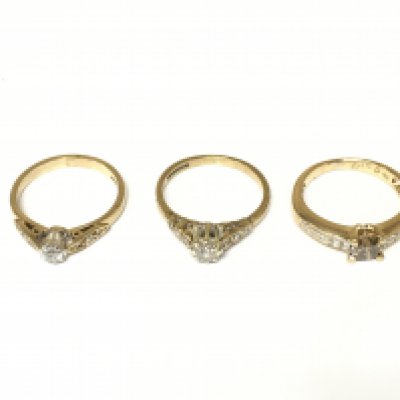 Three 9ct gold diamond solitaire rings with diamond shoulders. Approximately 5.6g and sizes I and I 1/2