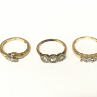 Three 9ct gold three stone diamond rings. Approximately 6.7g and sizes J and L