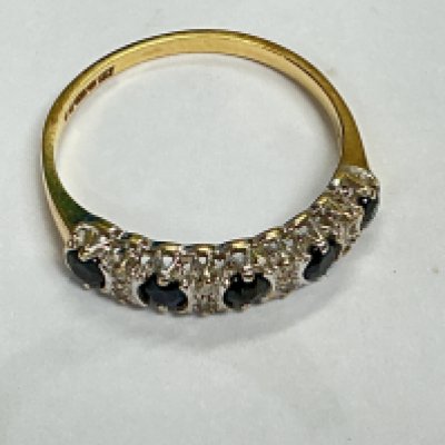 a 9ct gold ring with row set sapphires and small diamonds. Approx weight 1.50 grams, approx size M.