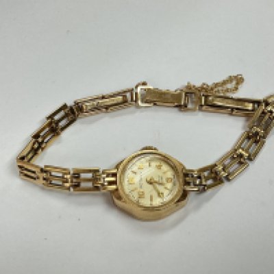 a 9ct gold ladies rotary watch with safety chain, approx weight without movement 9.25 grams.