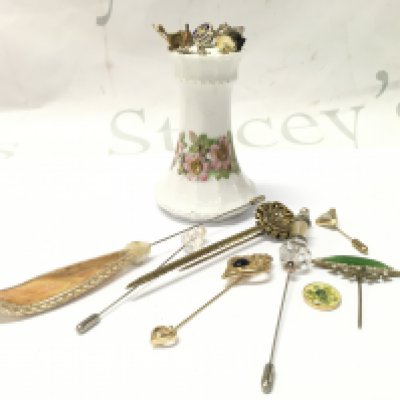 Stick pins , some silver . on stand . Approximately 20 pins . This lot cannot be posted