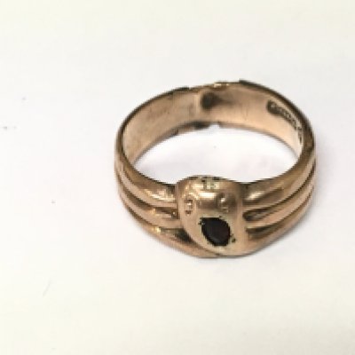 A 9ct gold ring of snake design set with a red stone. 2.75g size S