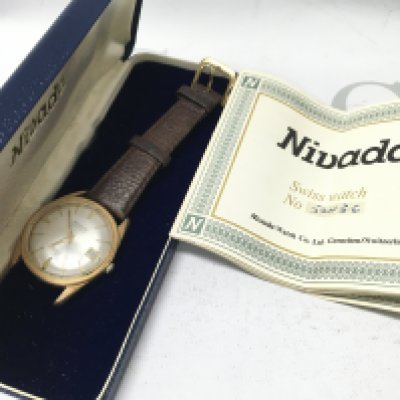 A boxed vintage gents Nivada Swiss automatic watch . Postage category A