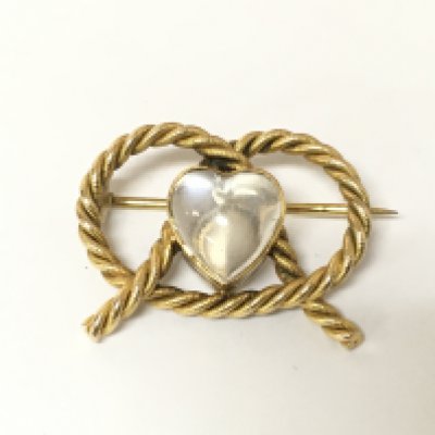 A 9ct gold lovers knot with moonstone. 5.09g