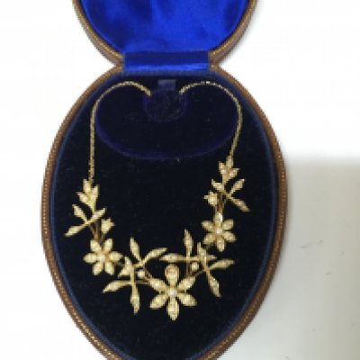 An Edwardian 15ct fiori design seed pearl necklace. 12g Postage B